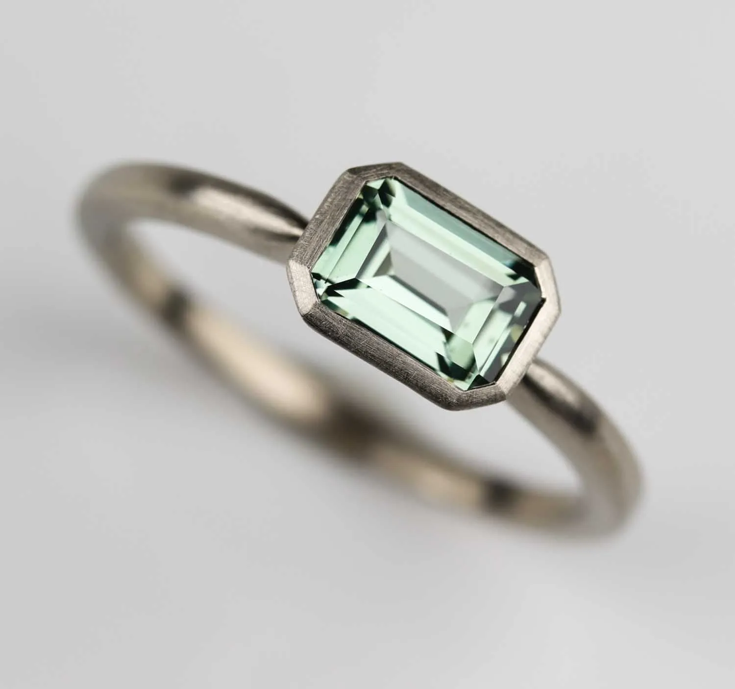 East West Bezel Solitaire Engagement Ring with Lab-grown Light Green Sapphire