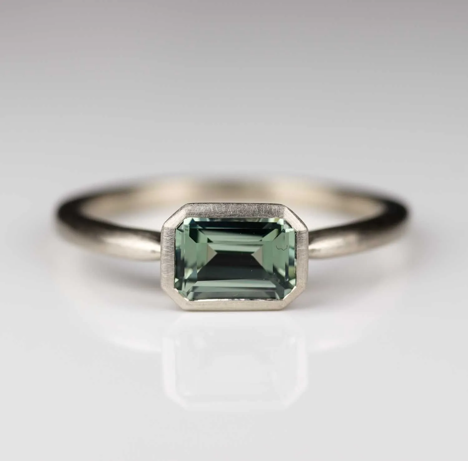 East West Bezel Solitaire Engagement Ring with Lab-grown Light Green Sapphire